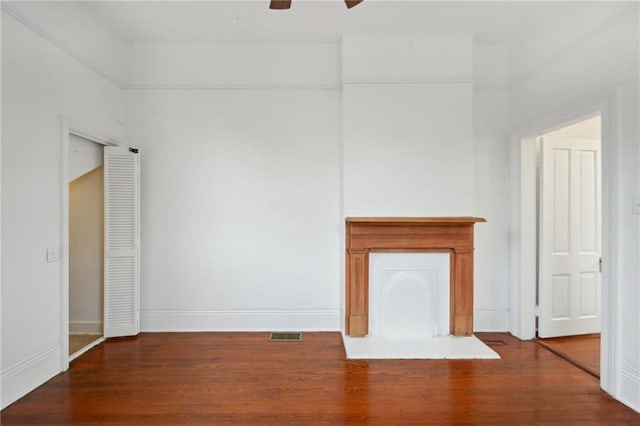 unfurnished living room featuring ceiling fan and hardwood / wood-style floors