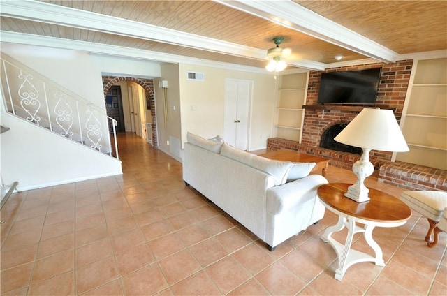 living room with a brick fireplace, wooden ceiling, built in features, and light tile patterned floors