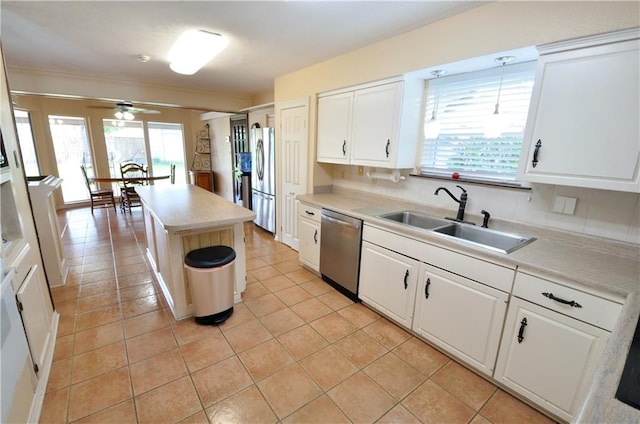 kitchen featuring a kitchen island, sink, pendant lighting, white cabinetry, and appliances with stainless steel finishes