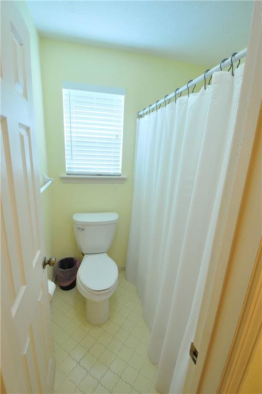 bathroom with walk in shower and toilet