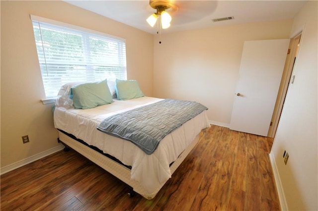 bedroom with ceiling fan and dark wood-type flooring