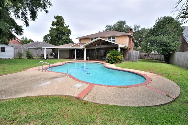 view of pool with a lawn and a patio area