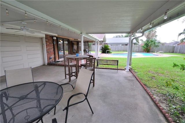 view of patio / terrace with ceiling fan and a fenced in pool