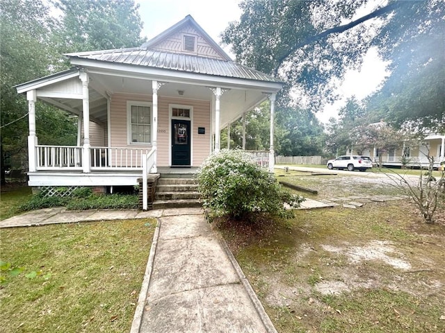 view of front of house with covered porch and a front yard