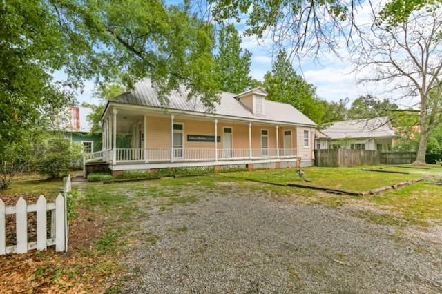 view of front of home with a front yard and a porch