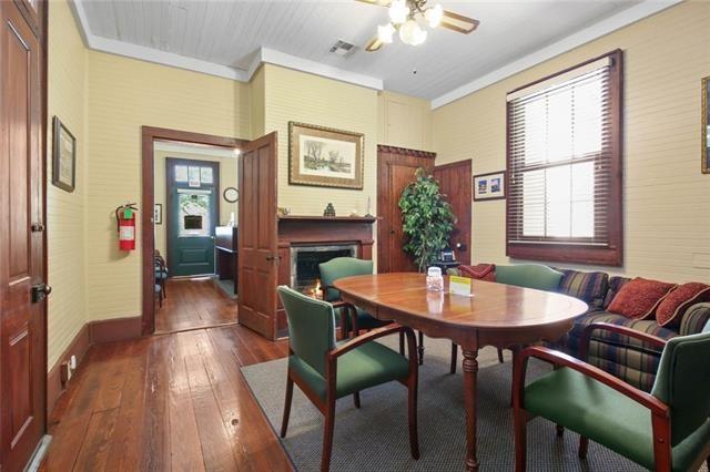 dining space with ornamental molding, hardwood / wood-style flooring, and ceiling fan