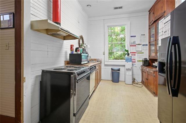 kitchen featuring wood walls and stainless steel appliances