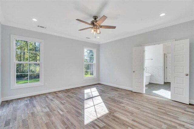 empty room with ceiling fan, ornamental molding, light hardwood / wood-style floors, and a healthy amount of sunlight