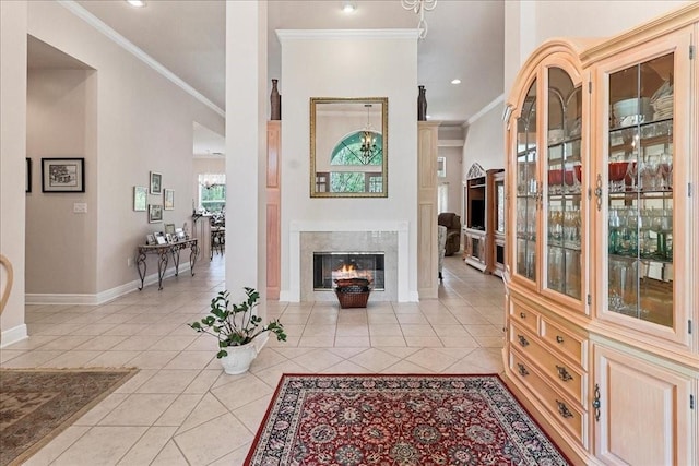 tiled living room featuring ornamental molding and a high end fireplace