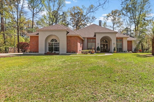 mediterranean / spanish house with a front yard