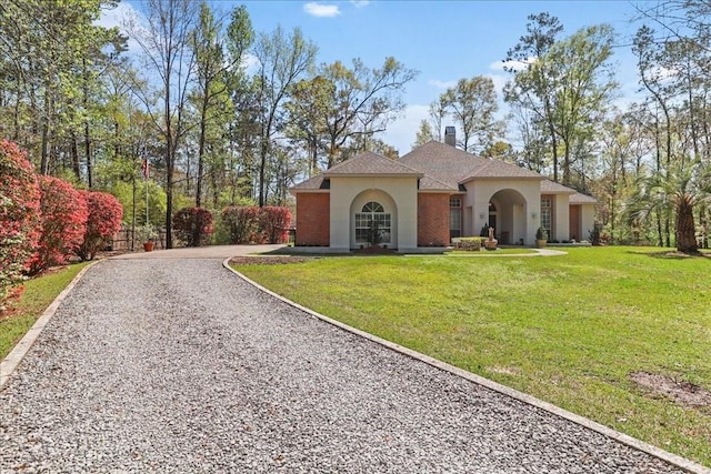 mediterranean / spanish-style home with a front lawn