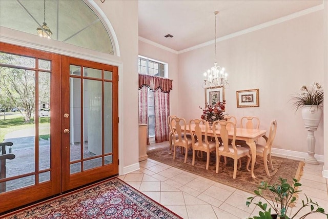 tiled dining space featuring french doors, an inviting chandelier, plenty of natural light, and ornamental molding