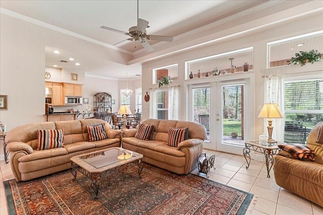 tiled living room featuring a high ceiling, ornamental molding, and ceiling fan