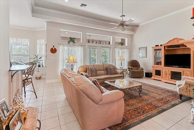 living room featuring light tile patterned floors, ornamental molding, and ceiling fan