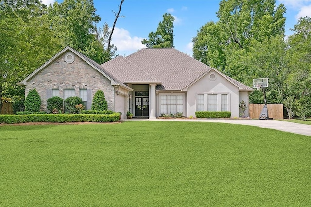 view of front facade with a garage and a front lawn