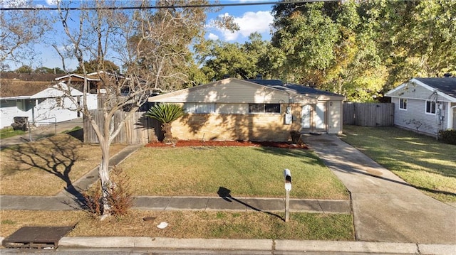 view of front of home with a front yard and a garage