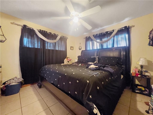 bedroom with ceiling fan and light tile patterned floors