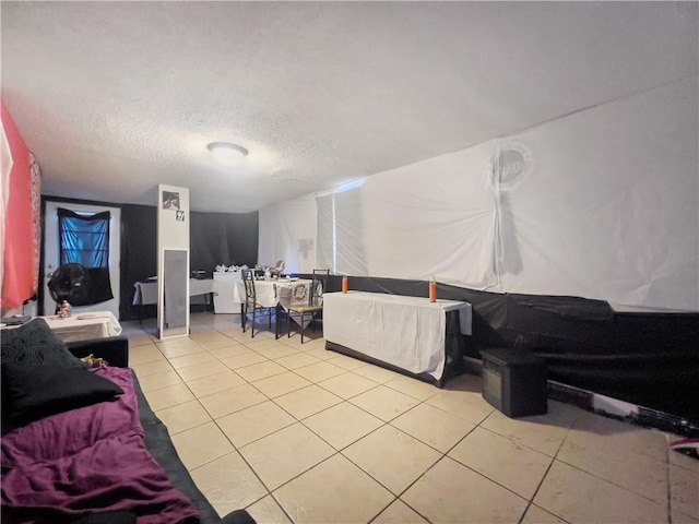 tiled living room featuring a textured ceiling