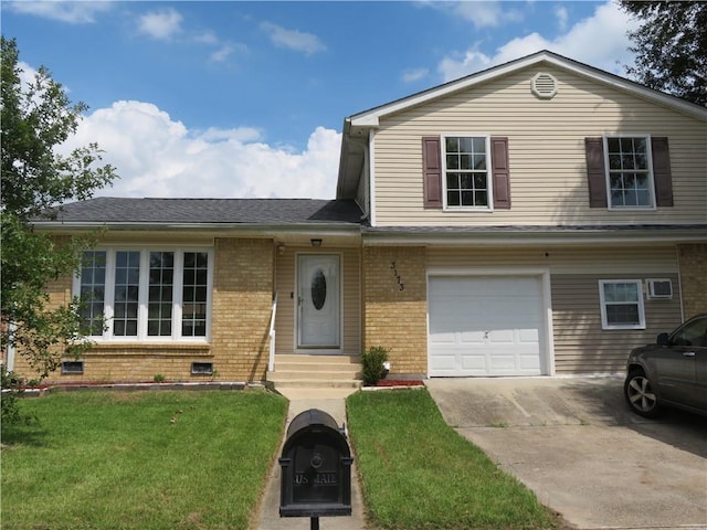 view of front of property with a front yard and a garage