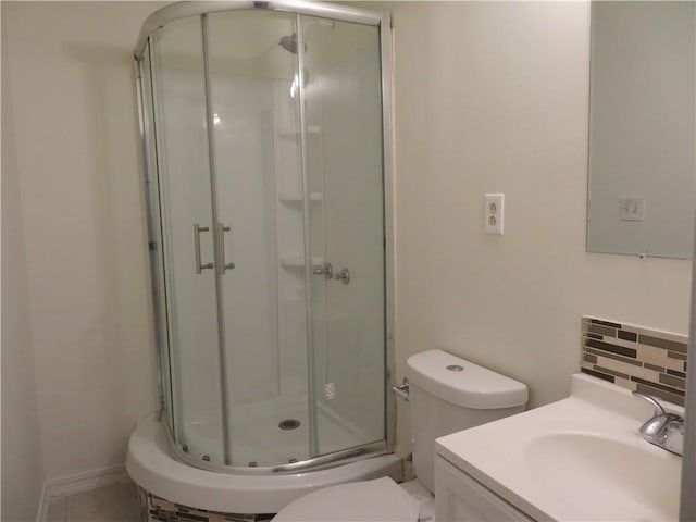 bathroom featuring vanity, toilet, decorative backsplash, and walk in shower