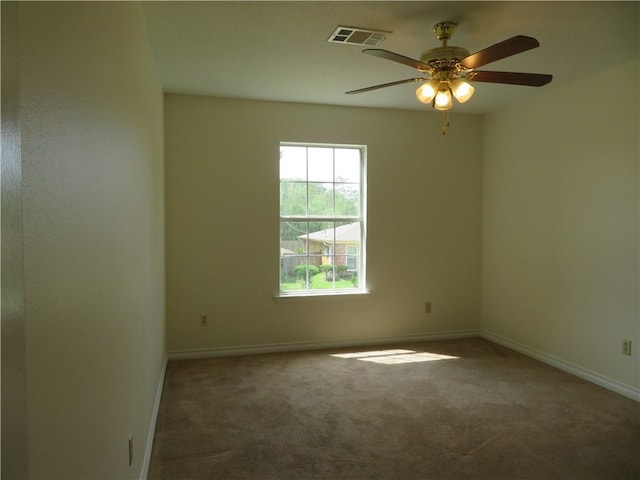 carpeted empty room featuring ceiling fan