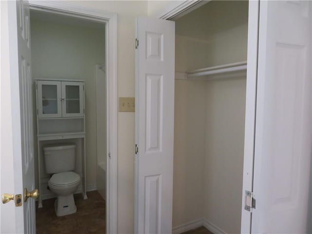 bathroom with toilet and shower / washtub combination