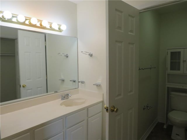 bathroom featuring vanity and toilet