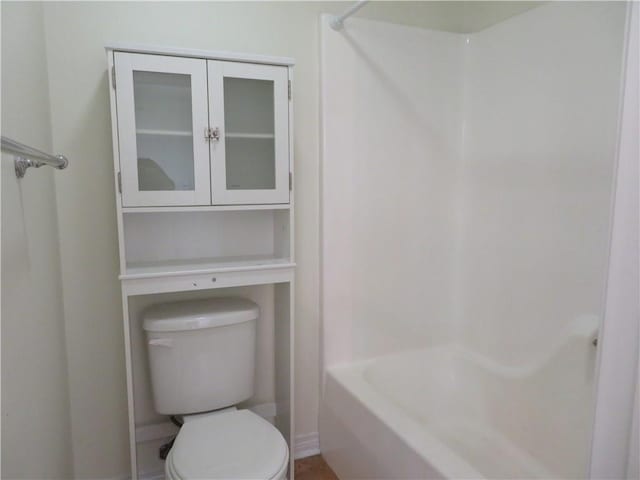 bathroom with toilet and bathing tub / shower combination