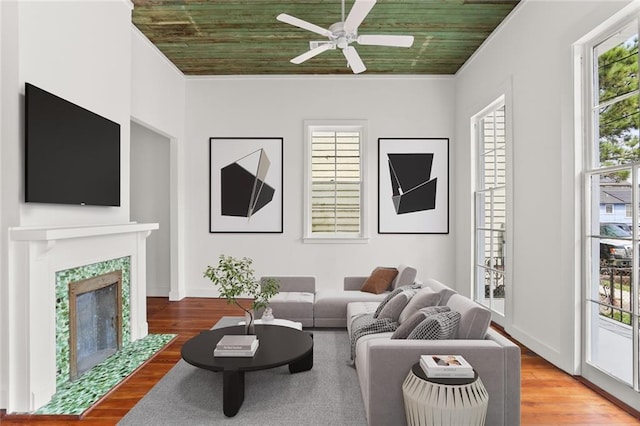 living room featuring wooden ceiling, a healthy amount of sunlight, hardwood / wood-style floors, and ceiling fan