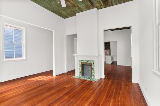 unfurnished living room with ceiling fan, crown molding, dark wood-type flooring, and wooden ceiling