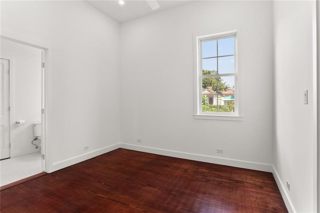 spare room with dark hardwood / wood-style flooring