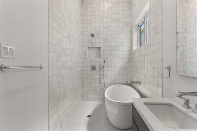 bathroom featuring vanity and tiled shower