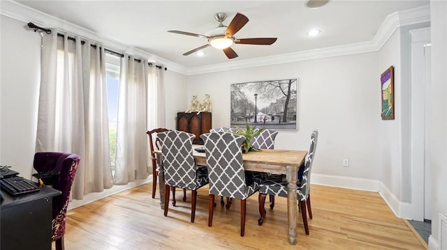 dining space featuring light hardwood / wood-style floors, ornamental molding, and ceiling fan