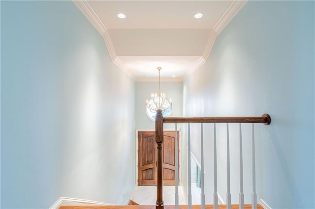 stairway with an inviting chandelier and ornamental molding