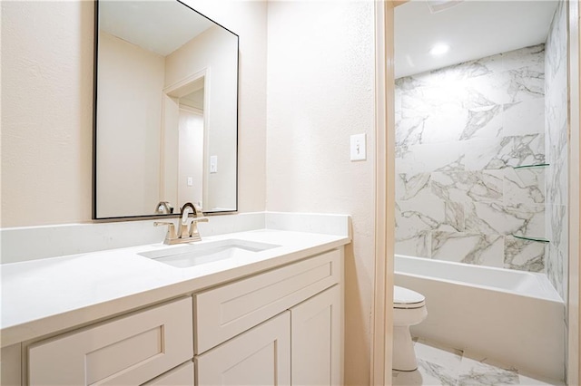 full bathroom featuring tiled shower / bath combo, vanity, and toilet