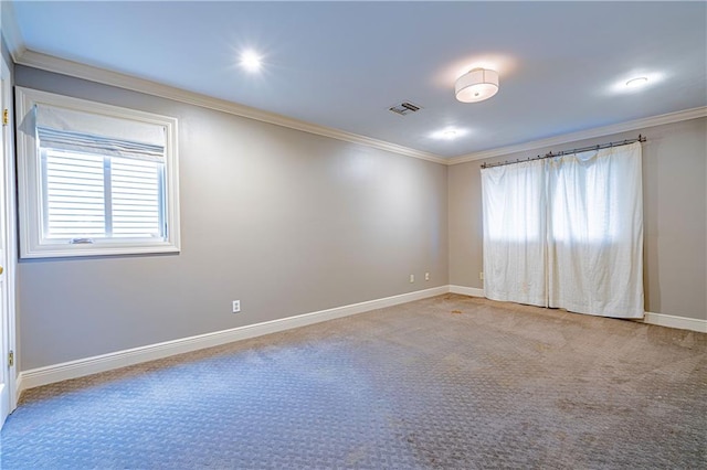 carpeted spare room featuring crown molding