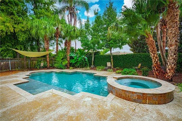 view of pool with an in ground hot tub