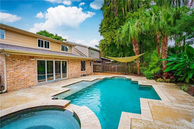 view of swimming pool featuring a patio and an in ground hot tub