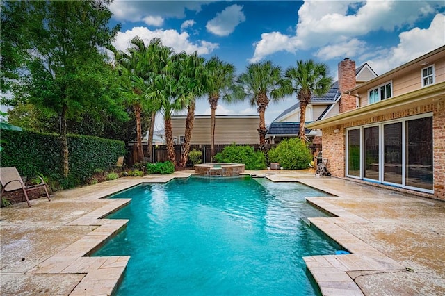 view of pool featuring a patio and an in ground hot tub