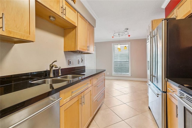 kitchen with stainless steel appliances, crown molding, sink, hanging light fixtures, and light tile patterned flooring