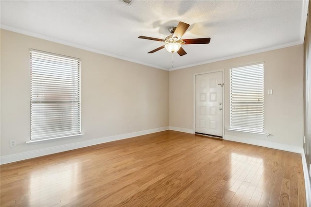 spare room featuring light hardwood / wood-style floors, ceiling fan, and crown molding