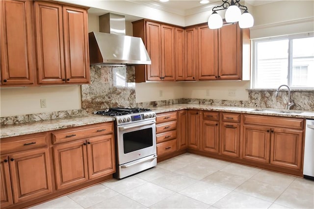 kitchen featuring sink, wall chimney range hood, high end stainless steel range, crown molding, and light stone countertops