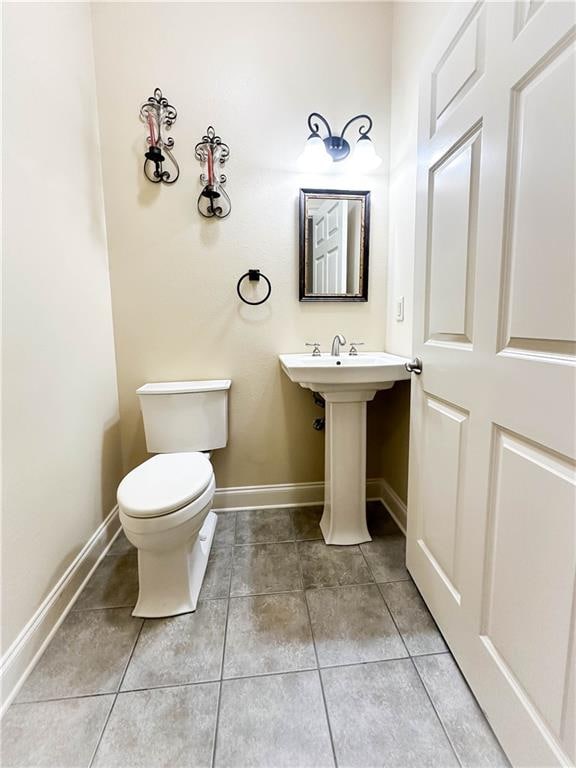 bathroom featuring tile patterned floors and toilet