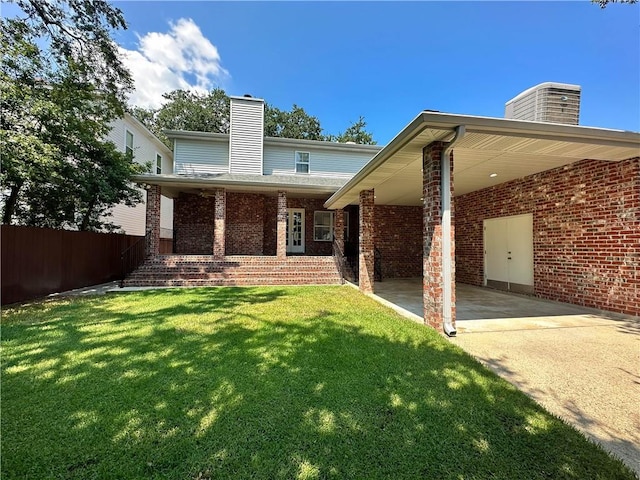 rear view of property featuring a lawn