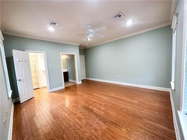 unfurnished bedroom with ceiling fan, light hardwood / wood-style flooring, crown molding, and ensuite bathroom