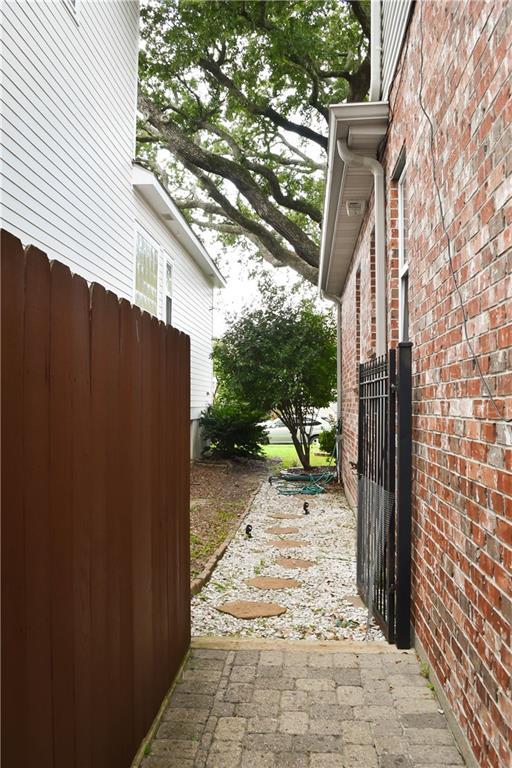 6613 Memphis St, New Orleans, LA 70124 - view of home's exterior with brick siding and fence