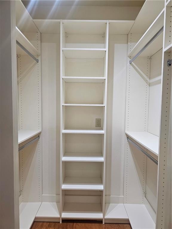 spacious closet with hardwood / wood-style flooring