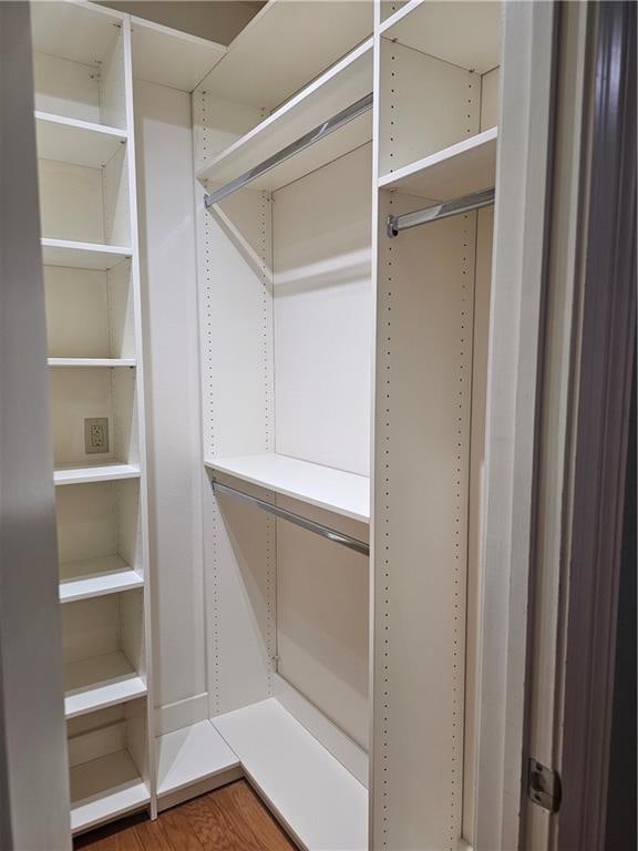 walk in closet with hardwood / wood-style floors