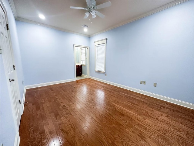 empty room featuring ceiling fan, crown molding, and hardwood / wood-style floors