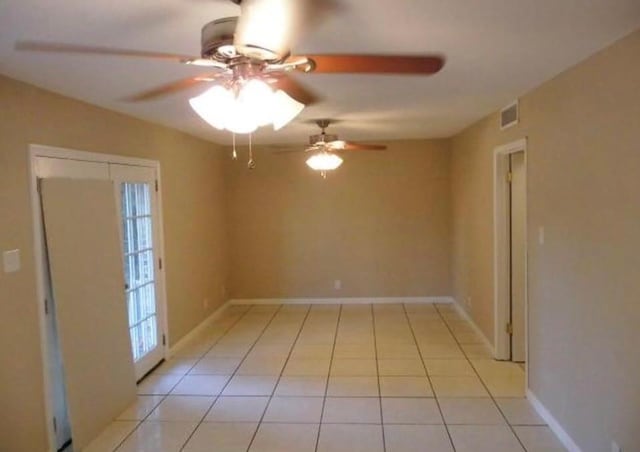 tiled empty room with ceiling fan